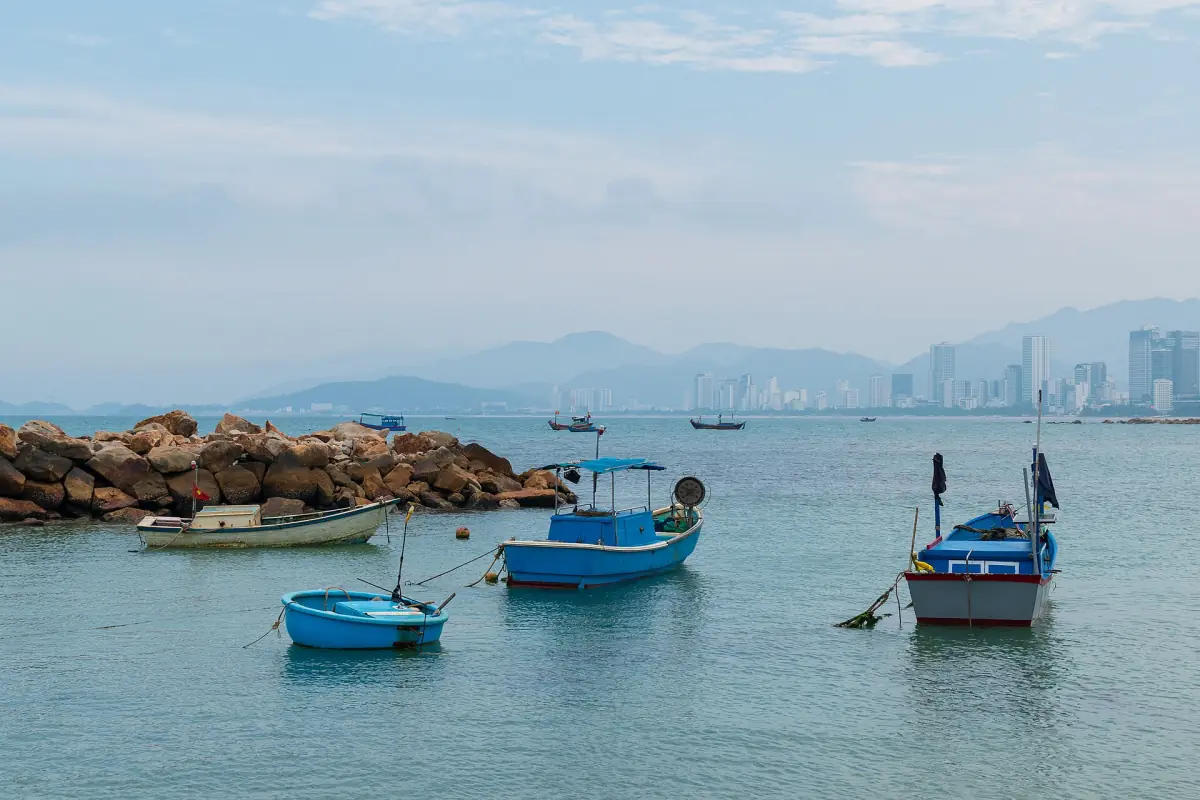 Fishing boats in the bay with the city behind