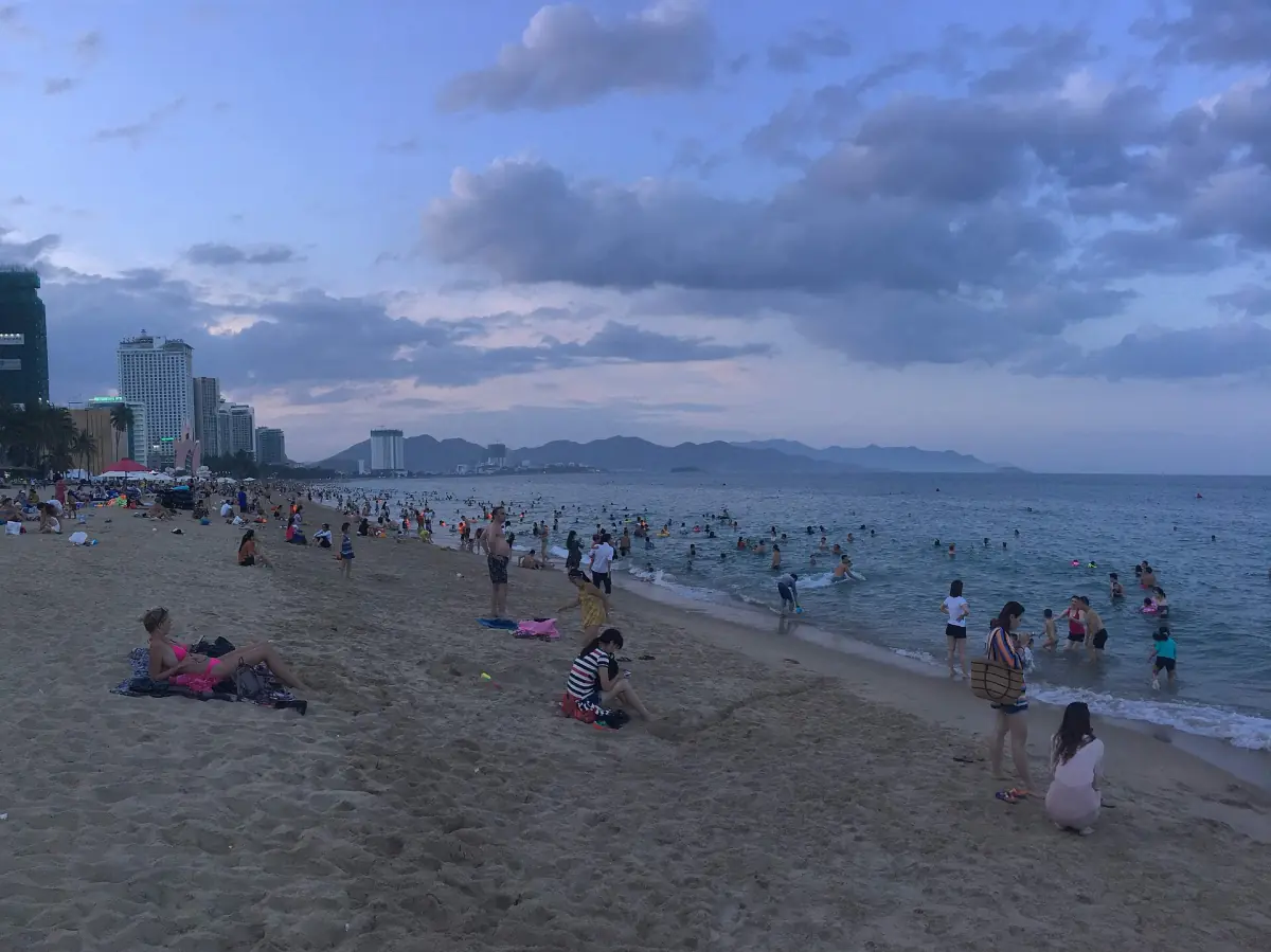 Swimmers on the city beach with hotels behind